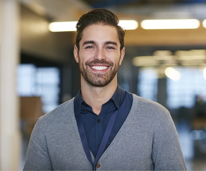 Man in grey jacket smiling