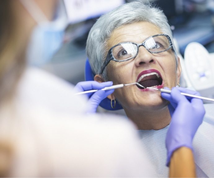 Woman having teeth cleaned by the dentist