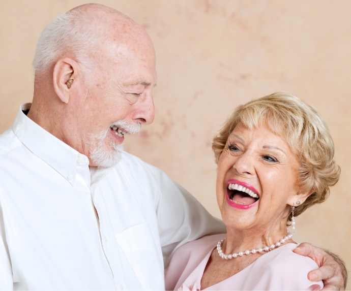 Man and woman holding each other and laughing