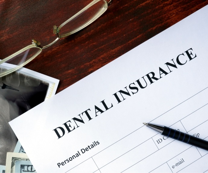 Dental insurance form on crowded desk