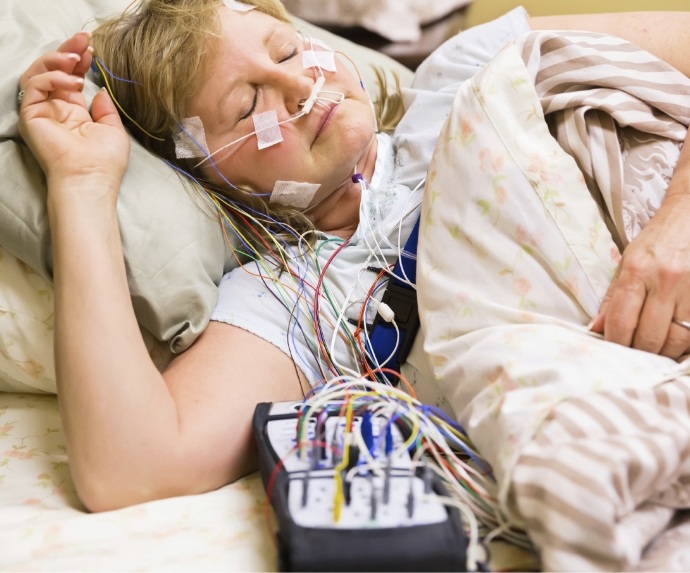 Woman in bed having a sleep test performed