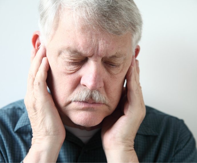 Senior man with jaw pain in need of TMJ treatment in Arlington