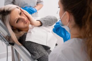 patient with a dental emergency in the dentist chair